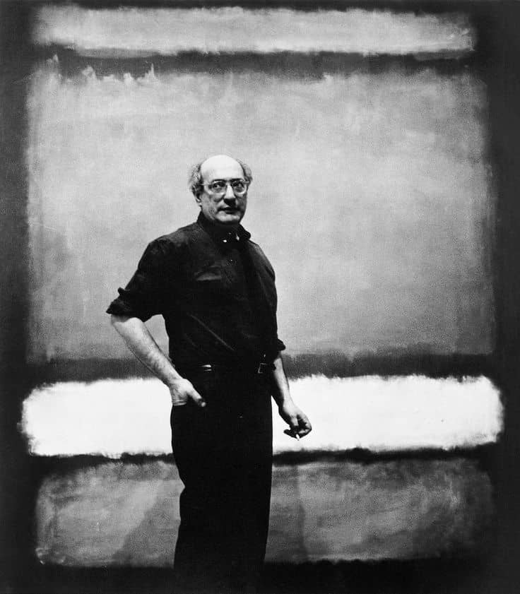 Mark Rothko standing in front of one of his large color field paintings, photographed in black and white, 1961.