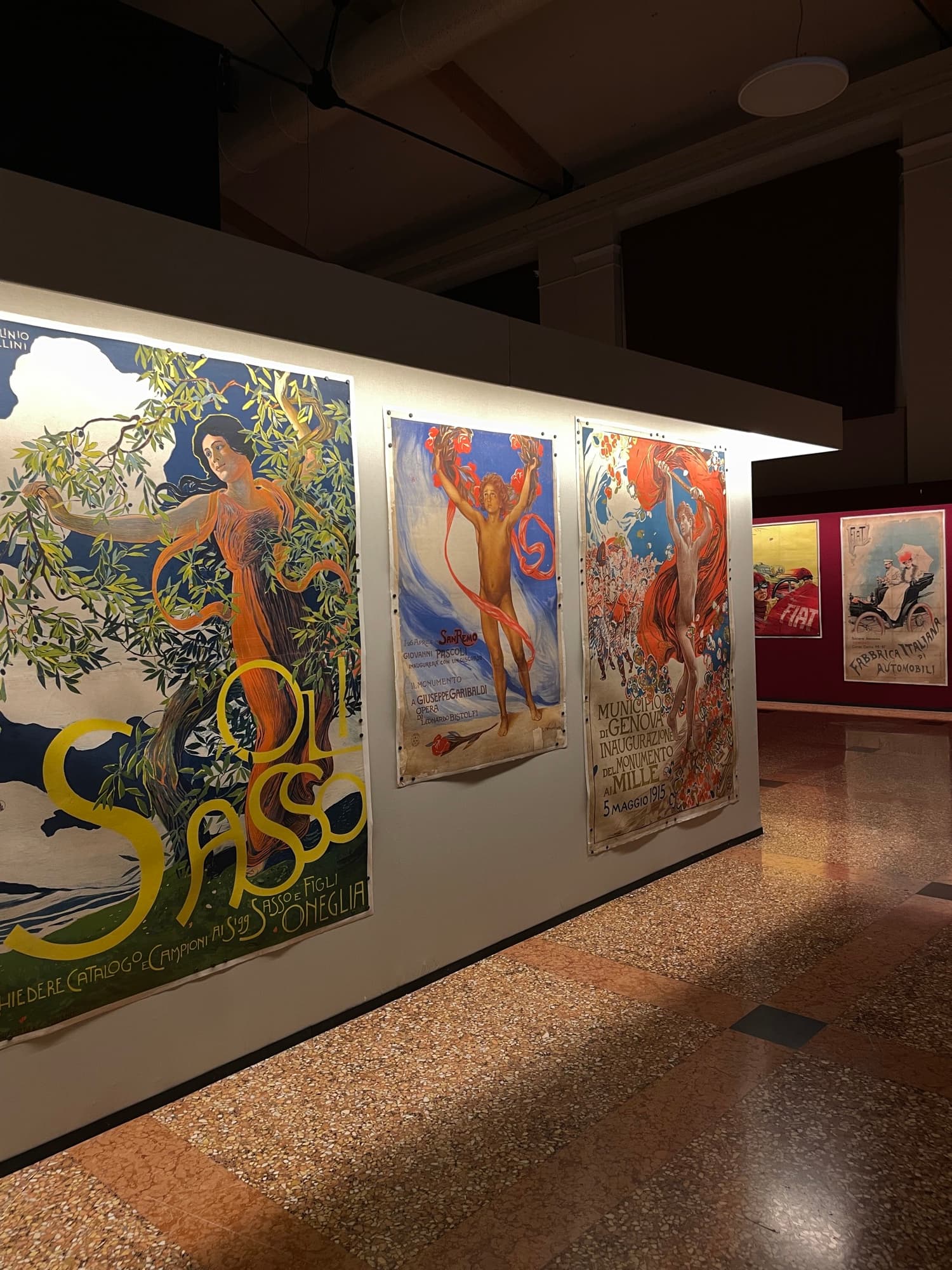 Large illustrated posters hung along a lit exhibition wall